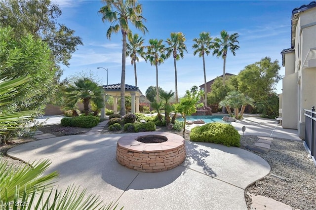 9008 Sawhill Pond St, Las Vegas, NV 89131 - view of patio / terrace with a gazebo, an outdoor fire pit, and an outdoor pool