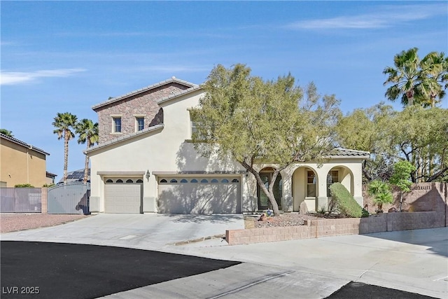 9008 Sawhill Pond St, Las Vegas, NV 89131 - view of front of property featuring a gate, stucco siding, concrete driveway, an attached garage, and a tiled roof