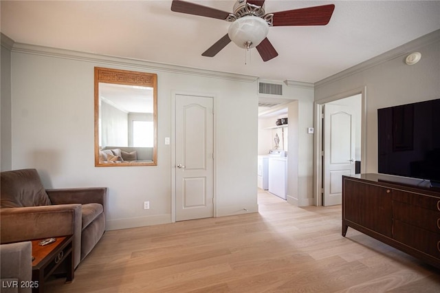 794 Oakmont Ave Unit 106, Las Vegas, NV 89109 - living area featuring ornamental molding, light wood-type flooring, baseboards, a ceiling fan, and washer and dryer