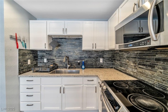 2708 Beaver Creek Ct Unit 202, Las Vegas, NV 89117 - kitchen featuring appliances with stainless steel finishes, a sink, and white cabinetry