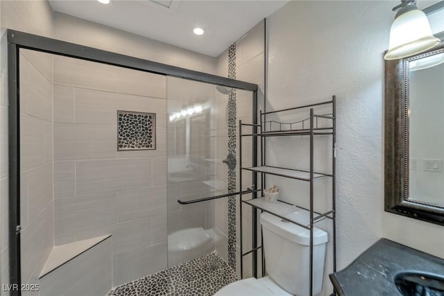2708 Beaver Creek Ct Unit 202, Las Vegas, NV 89117 - bathroom featuring toilet, a shower stall, a textured wall, vanity, and recessed lighting
