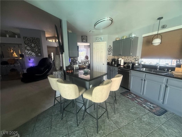 444 Viewmont Dr, Henderson, NV 89015 - kitchen with dishwashing machine, dark countertops, a sink, and healthy amount of natural light