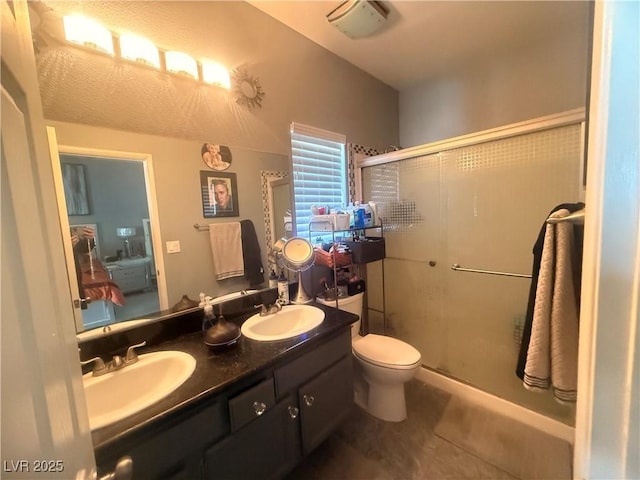 444 Viewmont Dr, Henderson, NV 89015 - bathroom with a stall shower, double vanity, tile patterned floors, and toilet
