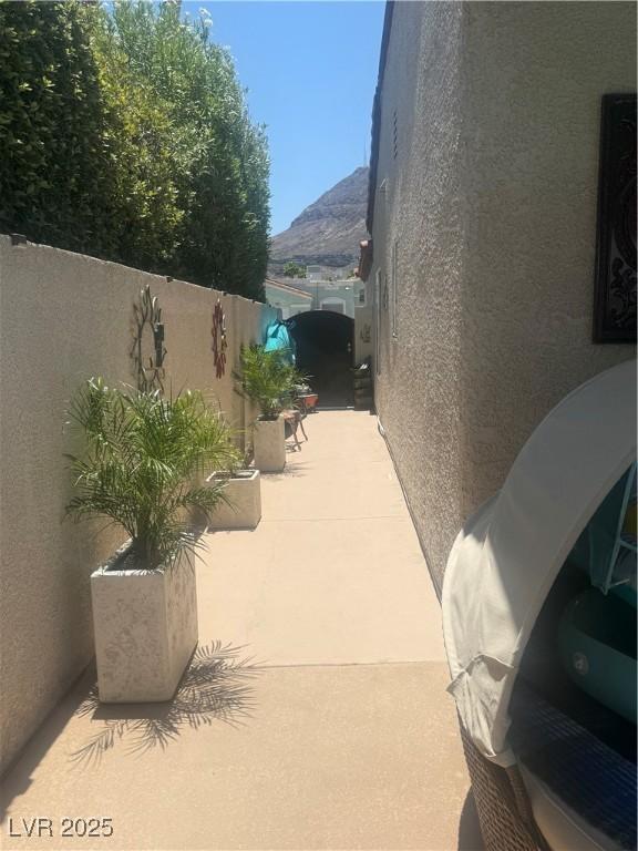 444 Viewmont Dr, Henderson, NV 89015 - view of property exterior with stucco siding, a patio, and a mountain view