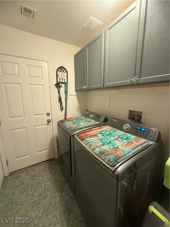 444 Viewmont Dr, Henderson, NV 89015 - laundry area featuring washing machine and clothes dryer, cabinet space, and dark tile patterned floors