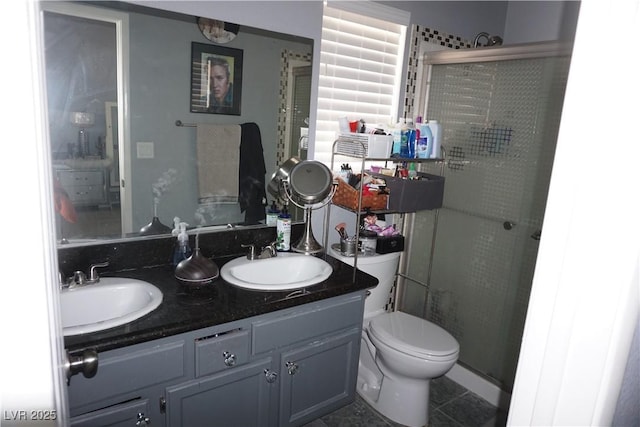 444 Viewmont Dr, Henderson, NV 89015 - bathroom featuring a stall shower, double vanity, toilet, and tile patterned floors