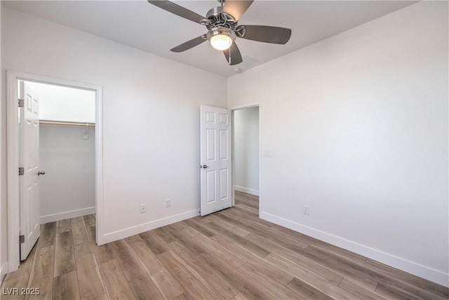 508 Cadence View Way, Henderson, NV 89011 - unfurnished bedroom featuring light wood-style flooring, baseboards, and a spacious closet