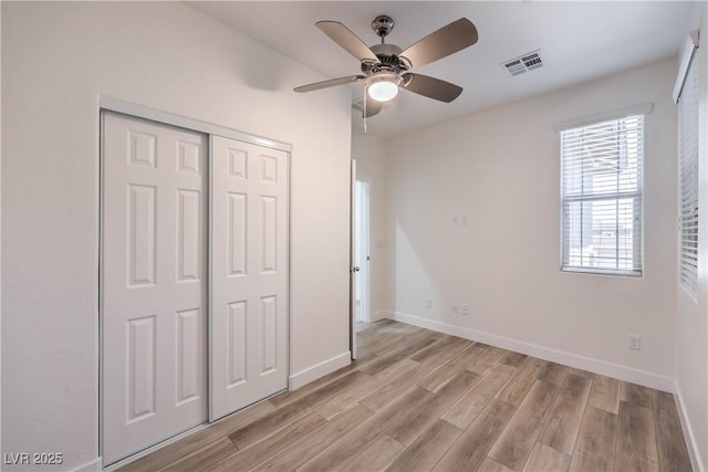508 Cadence View Way, Henderson, NV 89011 - unfurnished bedroom with light wood-type flooring, a closet, baseboards, and a ceiling fan