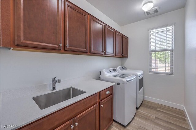 508 Cadence View Way, Henderson, NV 89011 - washroom with washer and dryer, cabinet space, baseboards, and light wood finished floors