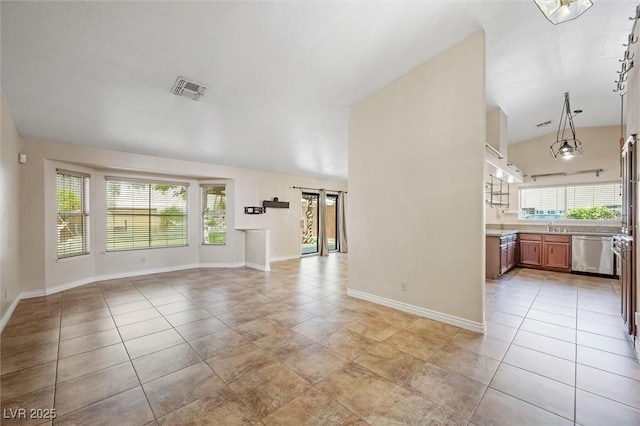 1929 Stonington Pl, Las Vegas, NV 89108 - unfurnished living room with vaulted ceiling, baseboards, light tile patterned floors, and a sink