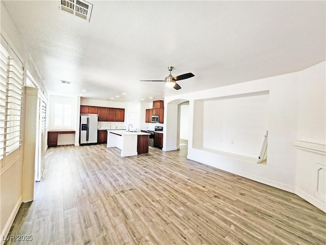 3829 N Mayfield Ranch Rd, Pahrump, NV 89060 - unfurnished living room with light wood-style floors, ceiling fan, arched walkways, baseboards, and recessed lighting