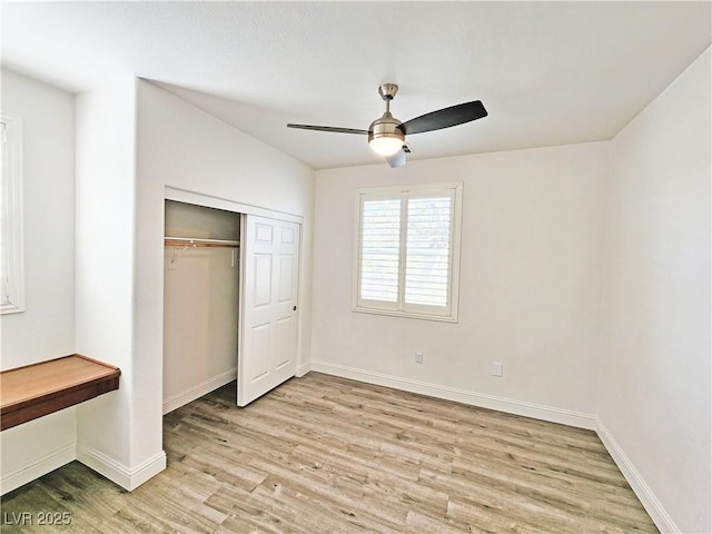 3829 N Mayfield Ranch Rd, Pahrump, NV 89060 - unfurnished bedroom featuring light wood-style flooring, a closet, baseboards, and ceiling fan