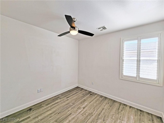 3829 N Mayfield Ranch Rd, Pahrump, NV 89060 - spare room with wood finished floors, baseboards, and ceiling fan