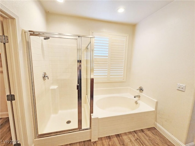 3829 N Mayfield Ranch Rd, Pahrump, NV 89060 - bathroom featuring a stall shower, a bath, wood finished floors, recessed lighting, and baseboards