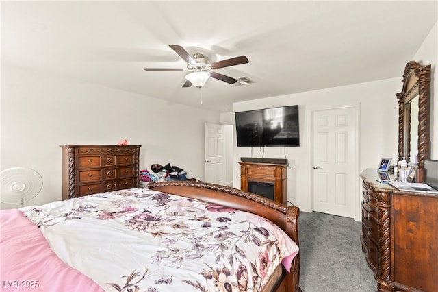 9161 Rolling Sky Dr, Las Vegas, NV 89178 - bedroom with carpet flooring, a fireplace, and a ceiling fan