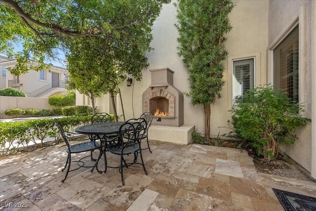 300 N Royal Ascot Dr, Las Vegas, NV 89144 - view of patio / terrace featuring a warm lit fireplace and outdoor dining area
