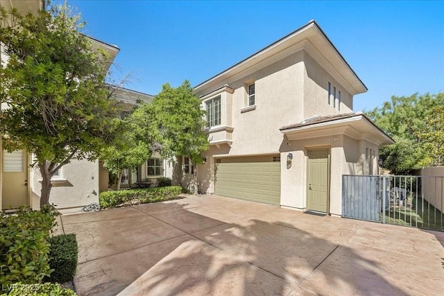300 N Royal Ascot Dr, Las Vegas, NV 89144 - view of front facade featuring stucco siding, an attached garage, and driveway