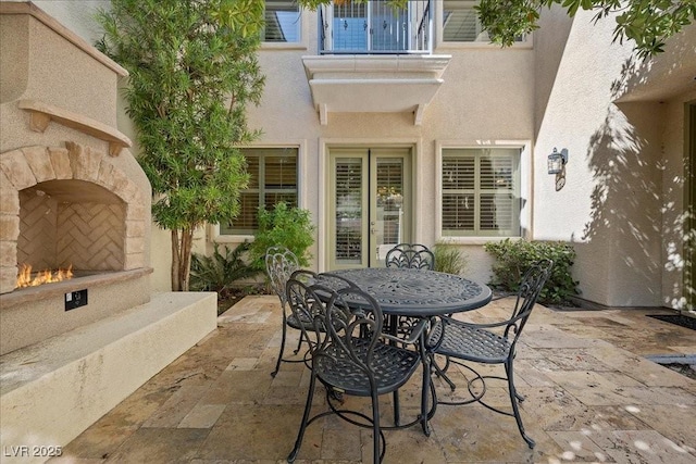 300 N Royal Ascot Dr, Las Vegas, NV 89144 - view of patio featuring an outdoor stone fireplace and outdoor dining space