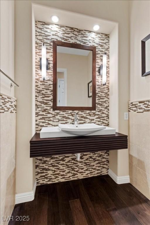 300 N Royal Ascot Dr, Las Vegas, NV 89144 - bathroom featuring wood finished floors, tile walls, and backsplash