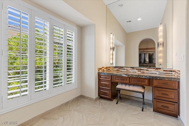 300 N Royal Ascot Dr, Las Vegas, NV 89144 - bathroom with tasteful backsplash, vanity, and plenty of natural light