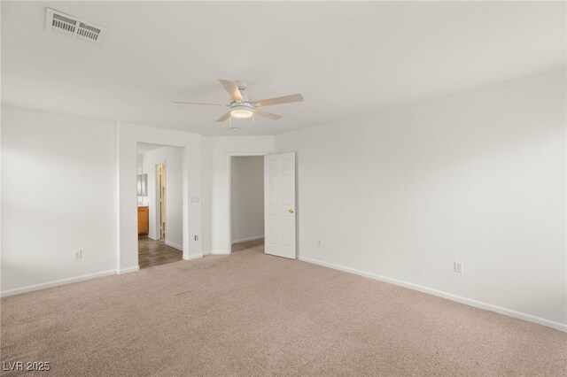 6480 Chebec St, North Las Vegas, NV 89084 - unfurnished bedroom with light carpet, a ceiling fan, and ensuite bath