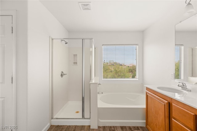 6480 Chebec St, North Las Vegas, NV 89084 - bathroom with a stall shower, a garden tub, vanity, and wood finished floors