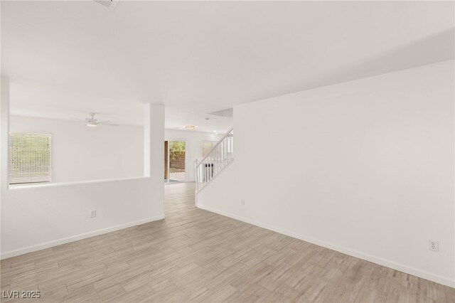 6480 Chebec St, North Las Vegas, NV 89084 - spare room featuring light wood-type flooring, ceiling fan, and stairs