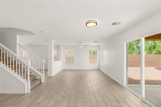 6480 Chebec St, North Las Vegas, NV 89084 - unfurnished living room featuring a ceiling fan, light wood-style flooring, and stairs
