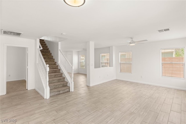 6480 Chebec St, North Las Vegas, NV 89084 - unfurnished living room featuring a ceiling fan, stairway, and light wood-style floors