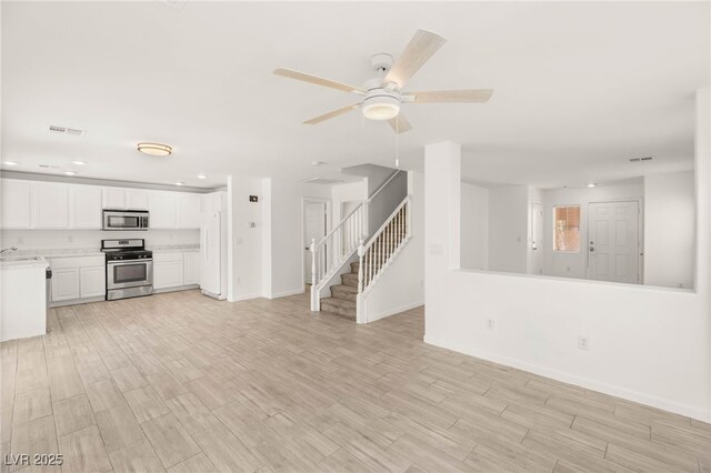 6480 Chebec St, North Las Vegas, NV 89084 - unfurnished living room with stairway, light wood-style flooring, recessed lighting, and ceiling fan