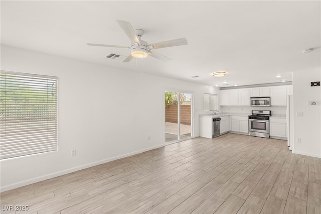 6480 Chebec St, North Las Vegas, NV 89084 - unfurnished living room featuring a ceiling fan, light wood-style floors, and recessed lighting