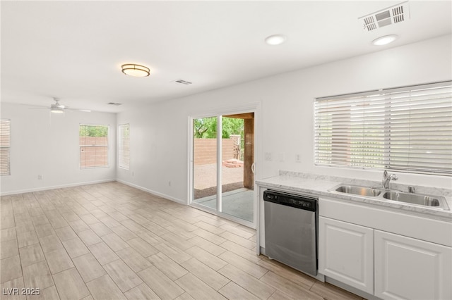 6480 Chebec St, North Las Vegas, NV 89084 - kitchen with dishwasher, healthy amount of natural light, ceiling fan, and white cabinets