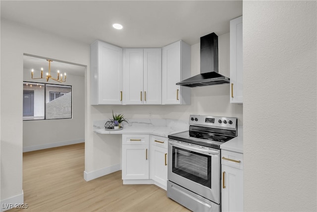 3151 Soaring Gulls Dr Unit 1179, Las Vegas, NV 89128 - kitchen with electric range, wall chimney exhaust hood, white cabinets, a chandelier, and recessed lighting
