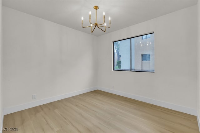 3151 Soaring Gulls Dr Unit 1179, Las Vegas, NV 89128 - spare room with a chandelier, wood finished floors, and baseboards