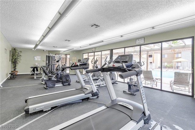 3151 Soaring Gulls Dr Unit 1179, Las Vegas, NV 89128 - exercise room featuring a textured ceiling and baseboards
