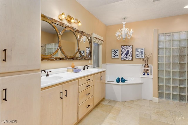 522 Via Ventana Dr, Mesquite, NV 89027 - bathroom featuring double vanity, a garden tub, and a chandelier