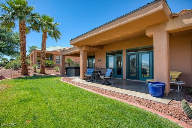 522 Via Ventana Dr, Mesquite, NV 89027 - back of house with stucco siding, a patio area, a yard, and a hot tub