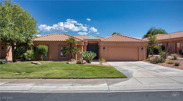 522 Via Ventana Dr, Mesquite, NV 89027 - view of front of home with a tile roof, an attached garage, a front yard, stucco siding, and driveway