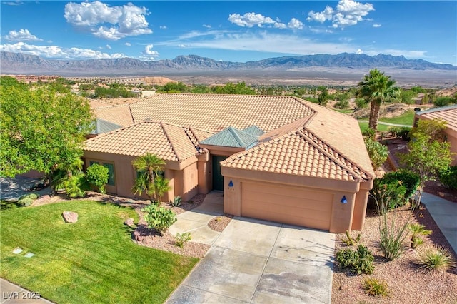522 Via Ventana Dr, Mesquite, NV 89027 - mediterranean / spanish home with an attached garage, a mountain view, a tiled roof, and concrete driveway