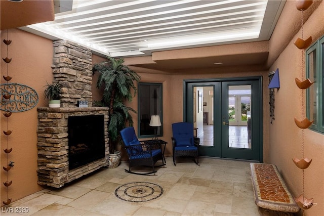 522 Via Ventana Dr, Mesquite, NV 89027 - view of exterior entry featuring french doors, a stone fireplace, a patio area, and stucco siding