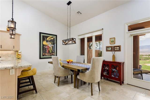 522 Via Ventana Dr, Mesquite, NV 89027 - dining room featuring light stone finish flooring and high vaulted ceiling