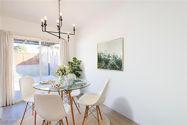 6170 W University Ave, Las Vegas, NV 89103 - dining room with a chandelier, wood finished floors, and baseboards