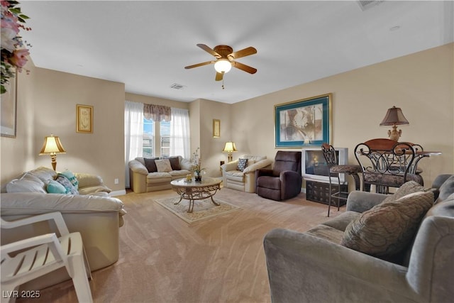 9614 Stonily Ln, Las Vegas, NV 89178 - living room featuring light colored carpet, a ceiling fan, and baseboards