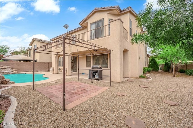 9614 Stonily Ln, Las Vegas, NV 89178 - back of property with stucco siding, a balcony, a fenced backyard, and a patio area