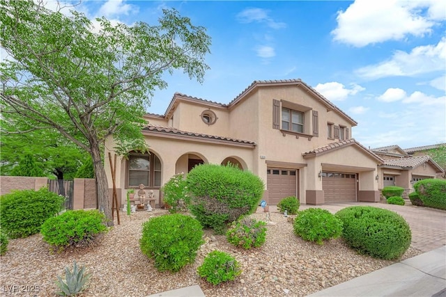 9614 Stonily Ln, Las Vegas, NV 89178 - mediterranean / spanish-style home with stucco siding, a tile roof, a garage, and driveway