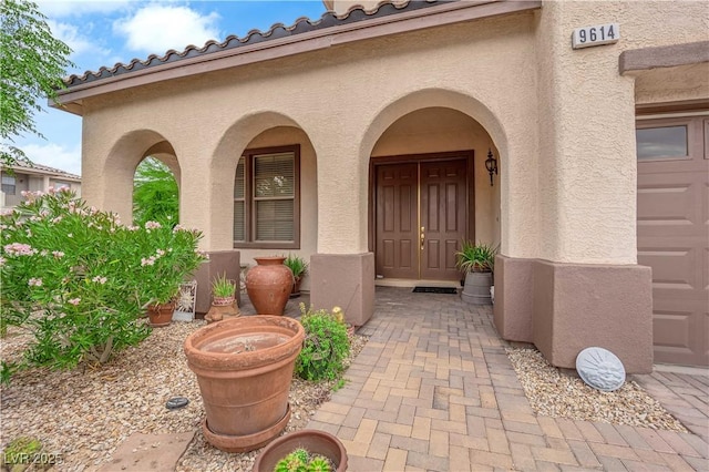 9614 Stonily Ln, Las Vegas, NV 89178 - view of exterior entry with stucco siding and a tiled roof