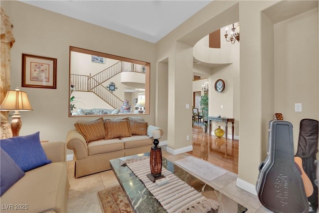 9614 Stonily Ln, Las Vegas, NV 89178 - tiled living room with a chandelier, baseboards, and stairway
