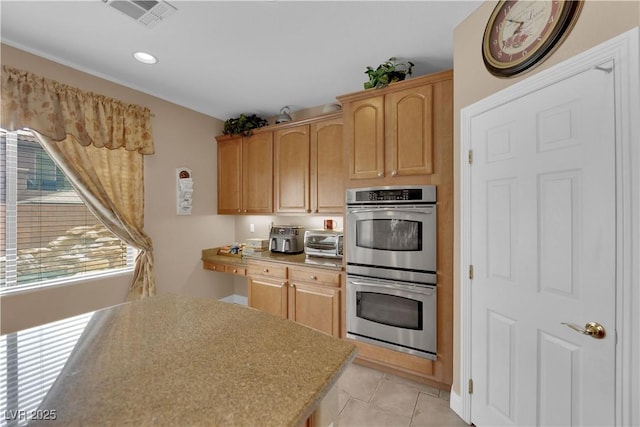 9614 Stonily Ln, Las Vegas, NV 89178 - kitchen featuring stainless steel double oven, light tile patterned floors, light countertops, recessed lighting, and light brown cabinets