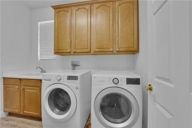 9614 Stonily Ln, Las Vegas, NV 89178 - laundry room with separate washer and dryer, cabinet space, and light wood-type flooring