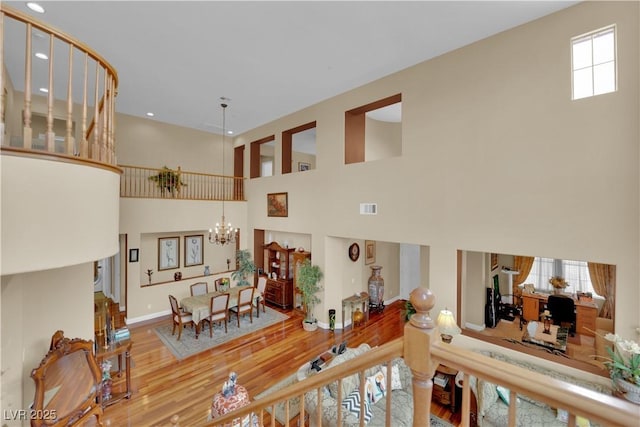 9614 Stonily Ln, Las Vegas, NV 89178 - hall with wood finished floors, a towering ceiling, baseboards, a chandelier, and recessed lighting